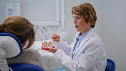Doctor Explaining Dental Implant Procedure to Patient Stomatology Clinic Closeup