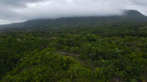 Aerial Drone Rises Up wet stormy skyline in Philippines Mountains, Jungle Tropical Green Trees and G