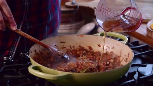 Cooking Vegetables in a Frying Pan on Stove