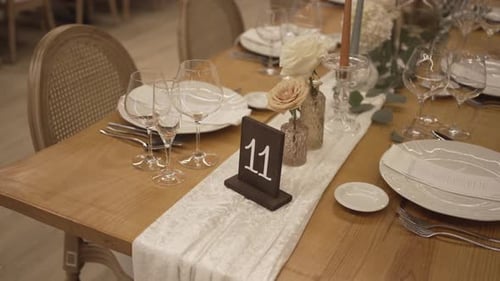 Wedding Table Setting with Flowers and Number Eleven