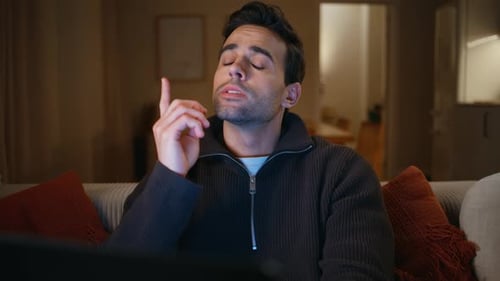 Man Thinks While Looking at a Device at Home