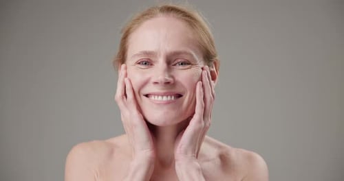 Smiling Woman Holding Her Face in Close Up