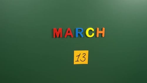 Hand sticking a sticker 13 March calendar day on school board. 13 date of March. Thirteenth day