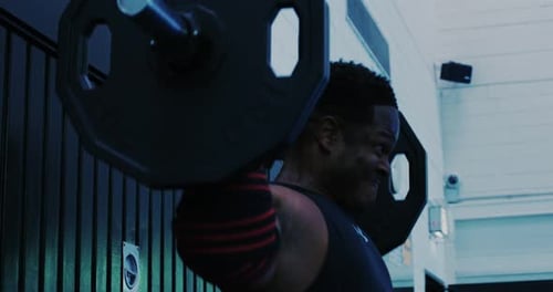 Black male powerlifter strongmen in empty gym training shoulders in Stuttgart, Germany, Europe