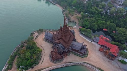 Sunlit pagoda of Sanctuary of Truth faces morning sea, Thailand