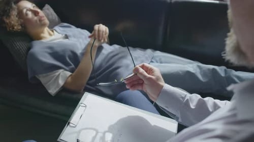 Mature Psychologist Working With Young Woman