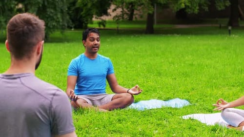 Fitness, Sport, Yoga and Healthy Lifestyle Concept - Group of People Meditating