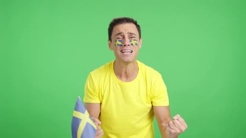 Man Cheering for Sweden During a Match That is Lost