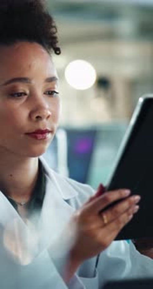 Scientist Woman Works with Tablet in Lab