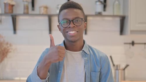 Smiling Young Adult Giving Thumbs Up