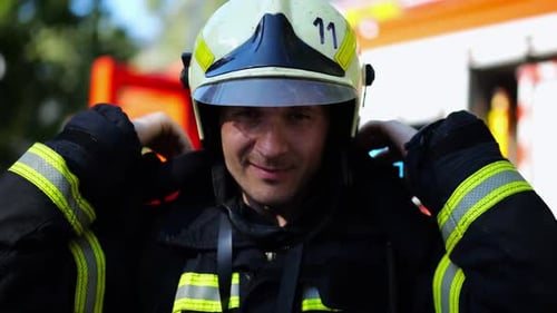 Firefighter Adjusts Helmet Preparing for Emergency