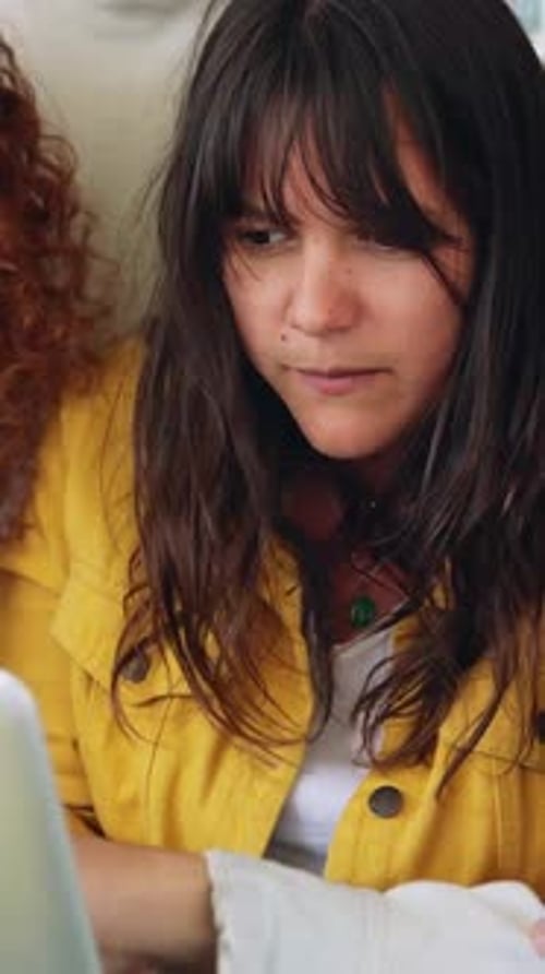 Young College Students Working Together on Laptop at Campus Library