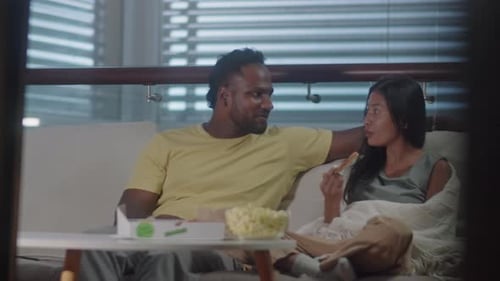 Couple Relaxing at Home with Pizza and Popcorn