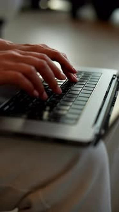 Close-up of Woman's Hands Typing on Laptop