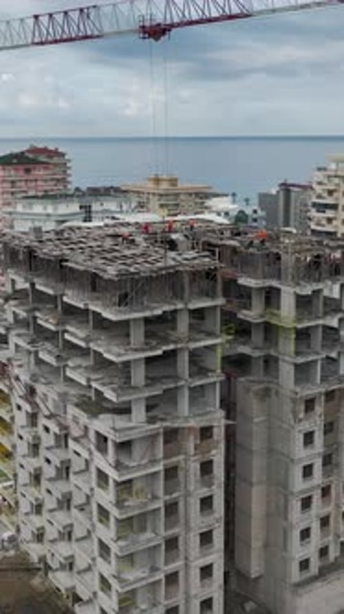 Vertical Video of Tall Structure Walls Built With Heavy Equipment