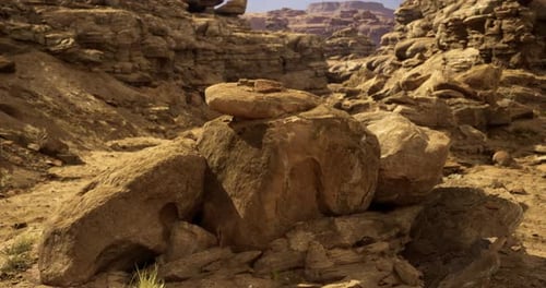 Unique Rock Formation in Rugged Desert Landscape Under Bright Sunlight