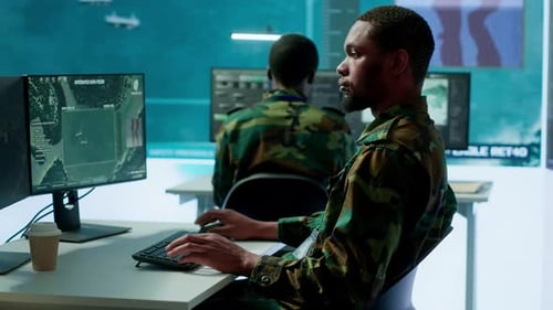 Military Personnel in a High Tech Command Center Monitor Satellite Feeds