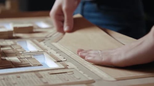 Hands of Professional Man Constructing Architecture Model of Urban Town Building
