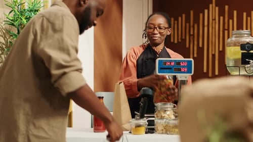 Customer Buying Glass Jars at Store Checkout
