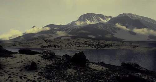 Beneath a Twilight Sky Towering Mountains Rise Above Tranquil Waters