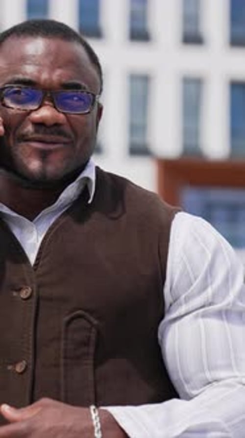 Handsome Man Talking on Phone Outside Building