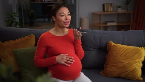 Pregnant Woman Using Voice Message on Smartphone