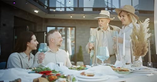 Family and Friends Celebrate a Meal Together Outdoors