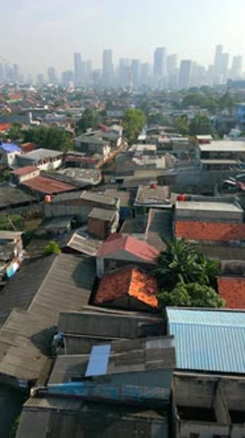 Aerial View of Jakarta City Skyline with Dense Housing and Modern Skyscrapers