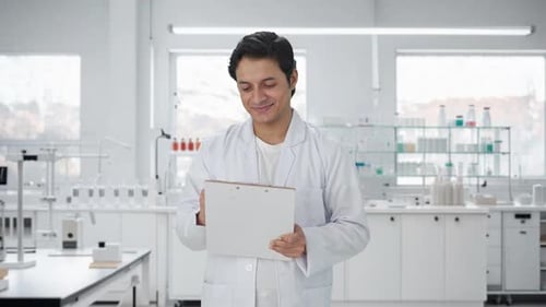 Scientist Writing on Clipboard in Modern Laboratory