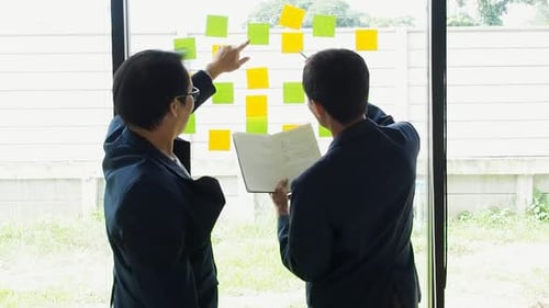 Business people meeting at office use digital tablet and sticky notes to share idea.