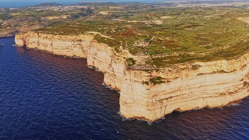 Stunning aerial view of Malta's rugged coastline and lush landscapes