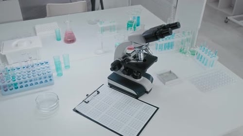 Microscope and Lab Equipment on White Table