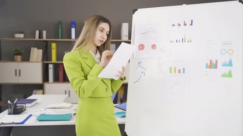 Businesswoman analyzing company charts.
