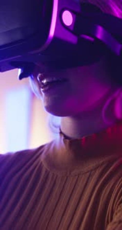 Woman Wearing Virtual Reality Headset in Dark Room