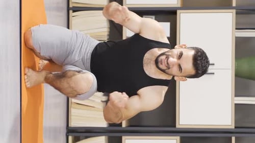 Muscular Man Exercising at Home on Yoga Mat
