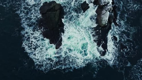 Waters of the Ocean Swirl Around the Rocky and Scenic Coastline Sea Waves Breaking Over Rocks