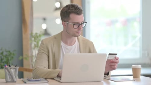 Young Adult Buys Online With Laptop and Card