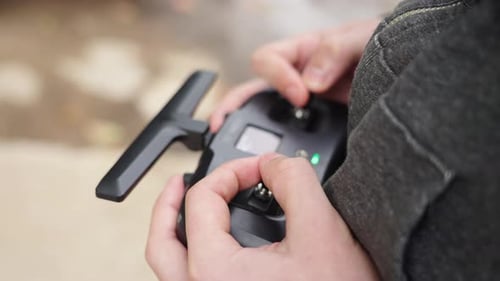 Pilot flying FPV Drone, close up of radio control