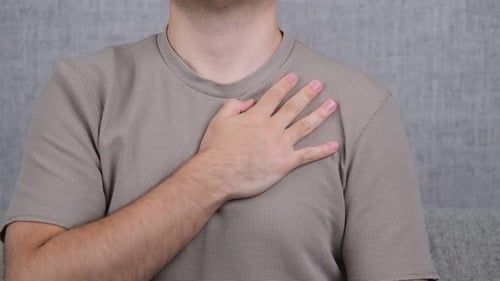 Man Rubbing Aching Shoulder in Pain