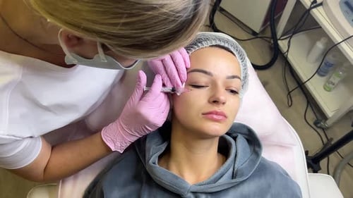 Cosmetologist Giving Woman Facial Filler Injection