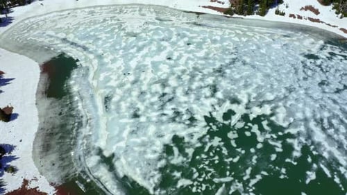 Aerial drone shot of Desolation Lake in Utah’s Big Cottonwood Canyon. Bird's eye view camera descend