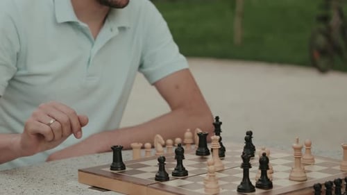 Man Playing Chess in Park