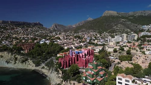 Aerial view of colorful buildings and coastline, Spain.