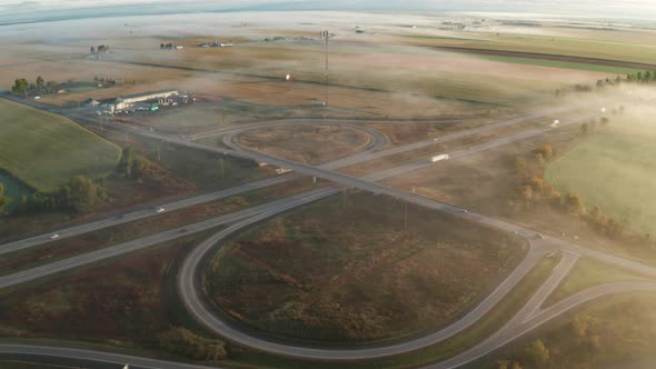 Morning fog over large highway cloverleaf on and off ramp ...