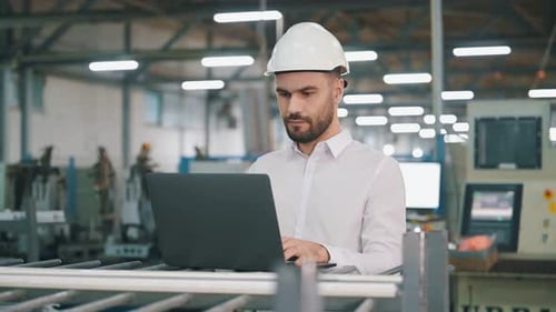 Busy at work. Man is in the modern factory.