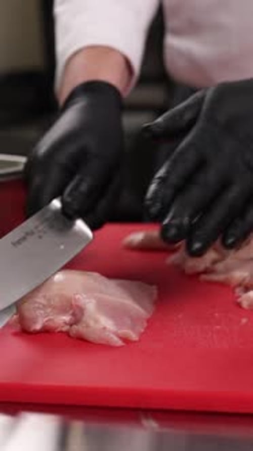 The chef prepares a dish of meat in the kitchen. Close-up