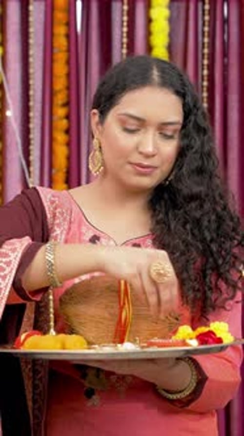 Woman Preparing Religious Offering in Pink Outfit