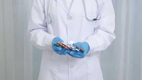 Medical Professional Holding Blister Packs of Pills