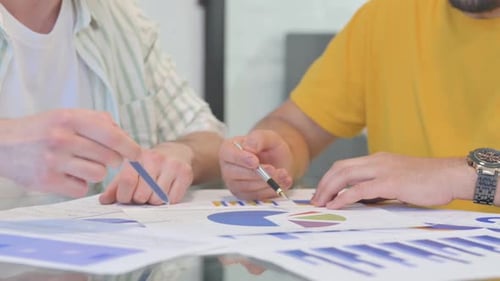 Close up of Male Hands Working on Documents