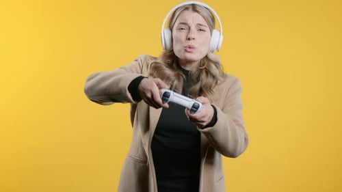 Young Pretty Gamer Woman Playingwins Online Video Game on Console with Gamepad